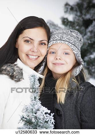 Stock Image - Mother and daughter, outdoor by winter. Fotosearch