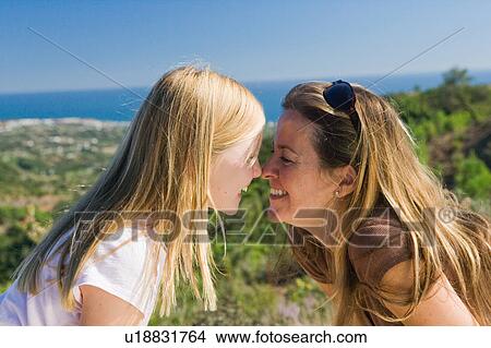 Mother and daughter smiling face to face View Large Photo Image Picture - Mother and daughter smiling face to face. Fotosearch