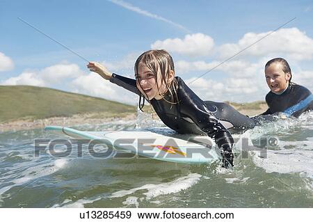 Stock Photo - Mother and daughter surfing. Fotosearch