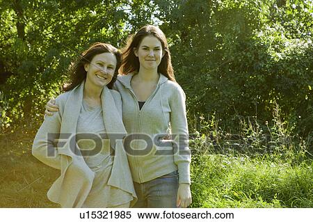 Stock Photography - Mother and daughter walking in park. Fotosearch