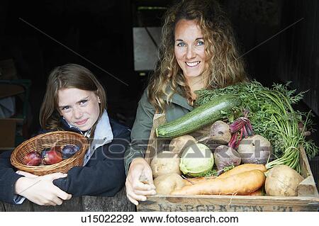 Mother and daughter with vegetables View Large Photo Image Stock Image - Mother and daughter with vegetables. Fotosearch