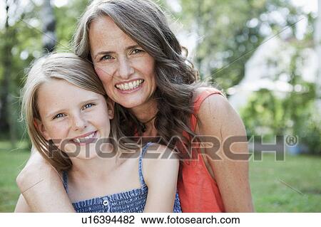 Stock Image - Mother and daugther in garden. Fotosearch