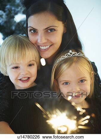 Mother and kids by snowy trees View Large Photo Image Stock Photograph - Mother and kids by snowy trees. Fotosearch