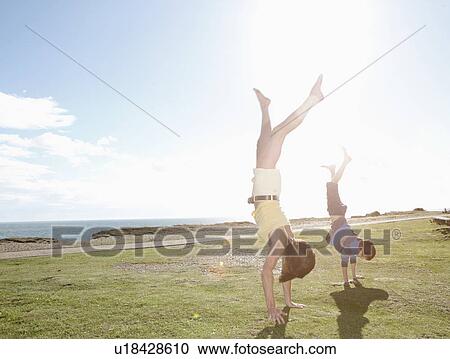 Mother and son doing hand stands View Large Photo Image Stock Image - Mother and son doing hand stands. Fotosearch