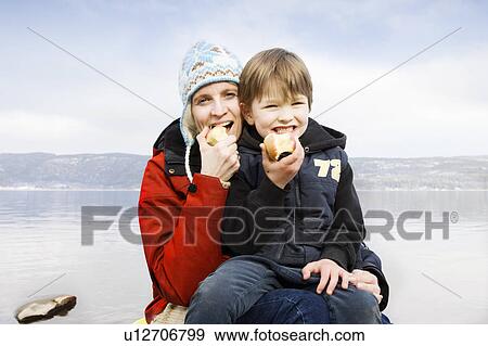 Stock Photo - Mother and son eating an apple. Fotosearch
