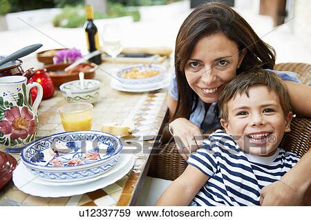 Mother and son having lunch View Large Photo Image Stock Photo - Mother and son having lunch. Fotosearch