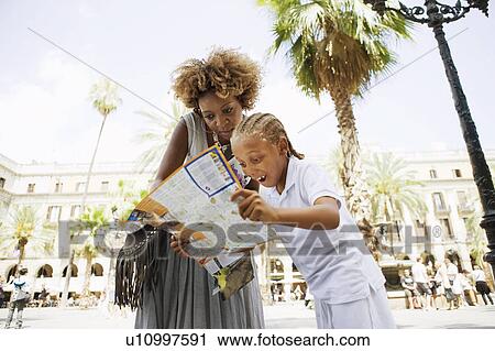 Mother and son looking at city map View Large Photo Image Stock Image - Mother and son looking at city map. Fotosearch