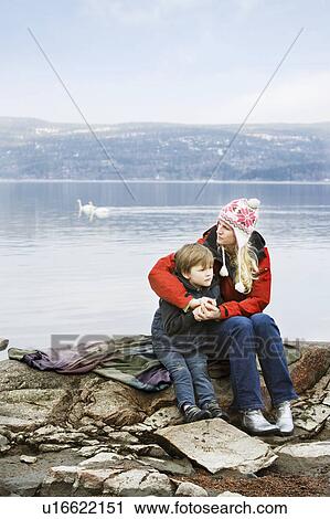 Mother and son relaxing at lake View Large Photo Image Stock Image - Mother and son relaxing at lake. Fotosearch