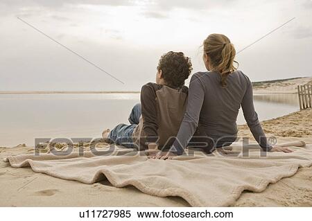 Mother and son sitting at beach View Large Photo Image Stock Photography - Mother and son sitting at beach. Fotosearch