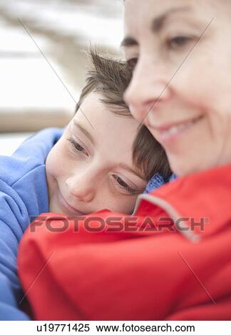 Mother and son snuggling together View Large Photo Image Stock Photography - Mother and son snuggling together. Fotosearch