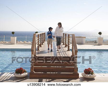 Mother and son walking on boardwalk View Large Photo Image Picture - Mother and son walking on boardwalk. Fotosearch