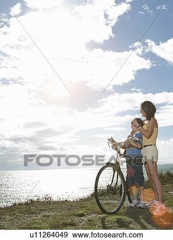 Stock Photo - Mother and son with bicycle. Fotosearch