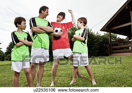 Stock Photograph - Mother celebrating different team. Fotosearch