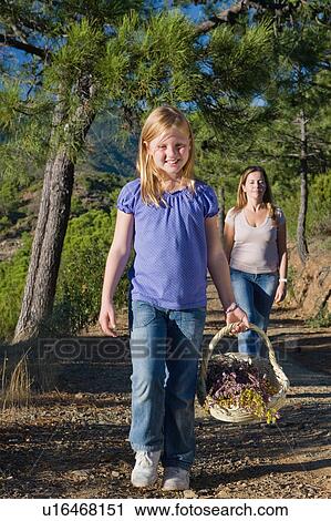 Mother & daughter collecting wild flower View Large Photo Image Stock Image - Mother & daughter collecting wild flower. Fotosearch