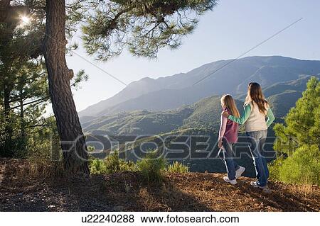 Mother & daughter overlooking mountains View Large Photo Image Stock Photo - Mother & daughter overlooking mountains. Fotosearch