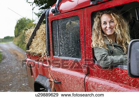 Stock Photo - Mother driving 4x4 on the farm. Fotosearch
