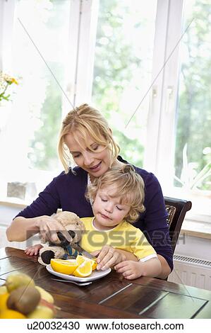 Mother feeding child View Large Photo Image Stock Image - Mother feeding child. Fotosearch