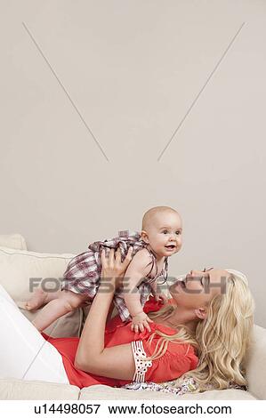 Stock Photo - Mother holding her baby. Fotosearch