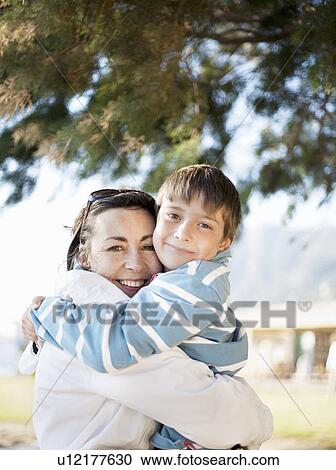 Mother hugging son View Large Photo Image Stock Image - Mother hugging son. Fotosearch