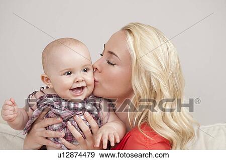 Mother kissing her baby View Large Photo Image Stock Photo - Mother kissing her baby. Fotosearch