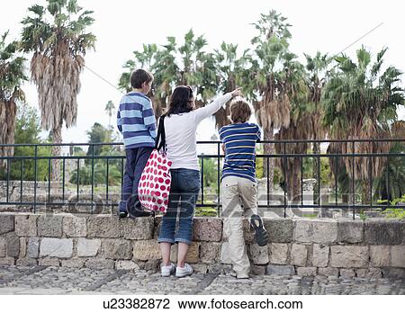 Mother looking at view with two boys View Large Photo Image Stock Image - Mother looking at view with two boys. Fotosearch