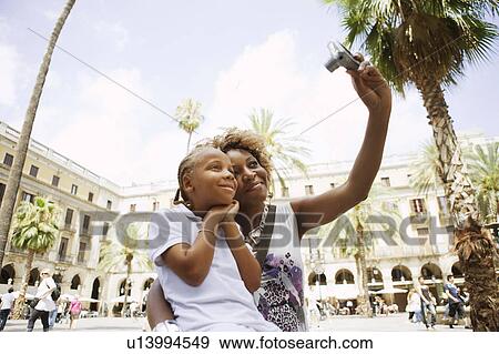 Mother taking a picture View Large Photo Image Stock Photo - Mother taking a picture. Fotosearch