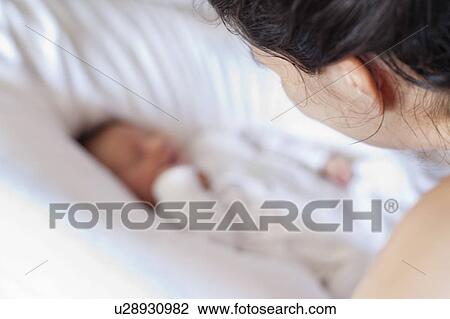 Mother watching over newborn baby View Large Photo Image Stock Image - Mother watching over newborn baby. Fotosearch
