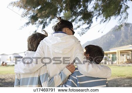 Mother with arms round two sons View Large Photo Image Stock Image - Mother with arms round two sons. Fotosearch