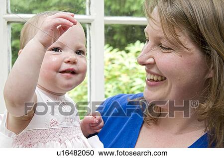 Mum and Daughter by window happy View Large Photo Image Stock Image - Mum and Daughter by window happy. Fotosearch