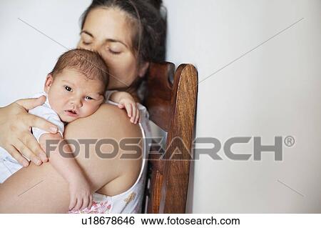 Newborn baby resting on mothers shoulder View Large Photo Image Stock Photograph - Newborn baby resting on mothers shoulder. Fotosearch
