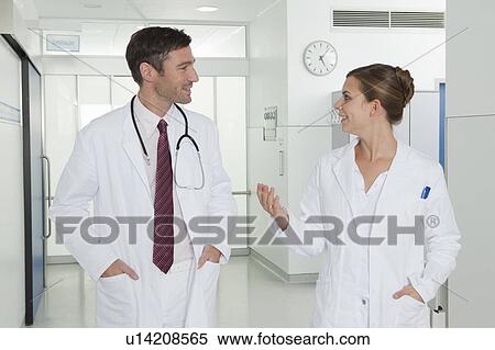 Nurse and doctor discussing in hall View Large Photo Image Stock Photography - Nurse and doctor discussing in hall. Fotosearch