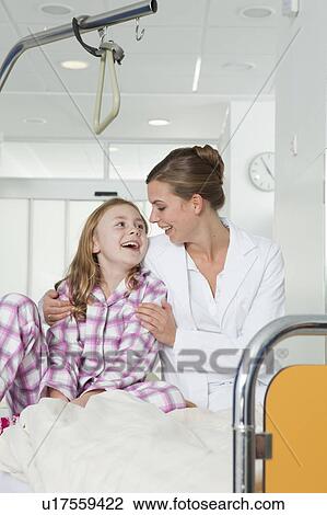 Nurse and girl in hospital bed, laughing View Large Photo Image Stock Image - Nurse and girl in hospital bed, laughing. Fotosearch