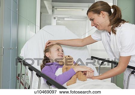 Stock Photo - Nurse caressing ill girl. Fotosearch