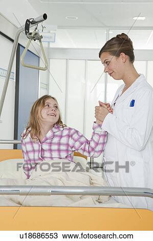 Nurse holding girls hand View Large Photo Image Stock Image - Nurse holding girls hand. Fotosearch