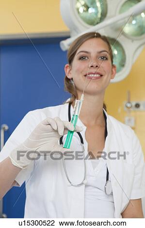 Nurse preparing injection, happy View Large Photo Image Stock Image - Nurse preparing injection, happy. Fotosearch