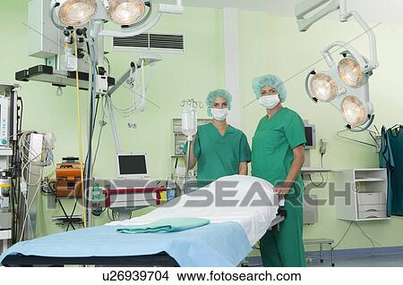 Nurses with scrubs in operation room View Large Photo Image Picture - Nurses with scrubs in operation room. Fotosearch