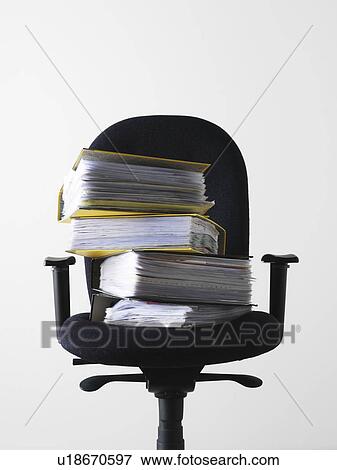 Stock Photo - Office chair with stack of files. Fotosearch