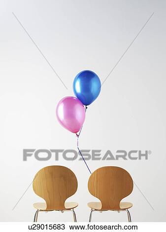 Stock Image - Office Chairs and connected balloons. Fotosearch