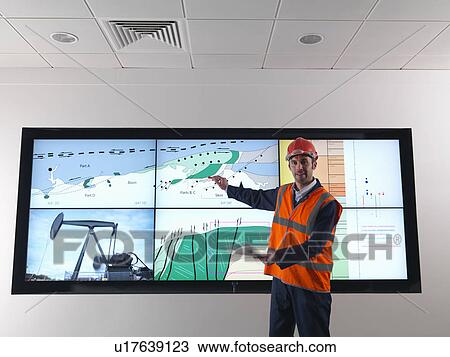 Oil worker with geology screen View Large Photo Image Stock Image - Oil worker with geology screen. Fotosearch