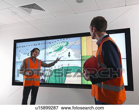 Oil workers with geology screen View Large Photo Image Stock Photo - Oil workers with geology screen. Fotosearch