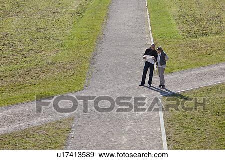 Stock Photo - Older couple with map at a crossroads. Fotosearch
