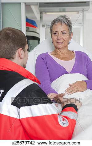 Stock Image - Paramedic caring about woman. Fotosearch