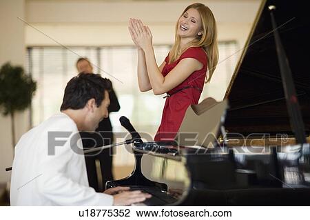 Piano player and singing girl View Large Photo Image Stock Image - Piano player and singing girl. Fotosearch