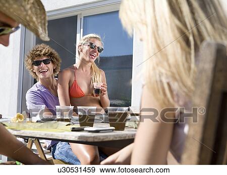 PLE sit at picnic table with friends View Large Photo Image Stock Photo - PLE sit at picnic table with friends. Fotosearch