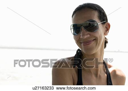 Stock Image - Portrait of a woman with sunglasses. Fotosearch