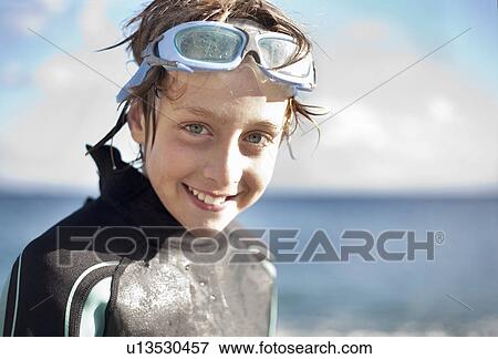 Stock Photo - Portrait of boy in wetsuit and goggles. Fotosearch
