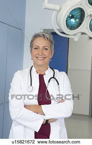 Stock Image - Portrait of female doctor, laughing. Fotosearch