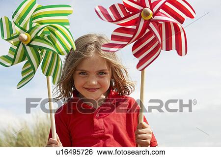 Portrait of girl with windmills View Large Photo Image Stock Photograph - Portrait of girl with windmills. Fotosearch