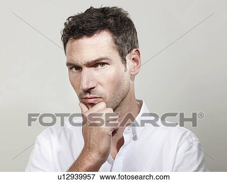 Portrait of man looking critical View Large Photo Image Stock Photo - Portrait of man looking critical. Fotosearch