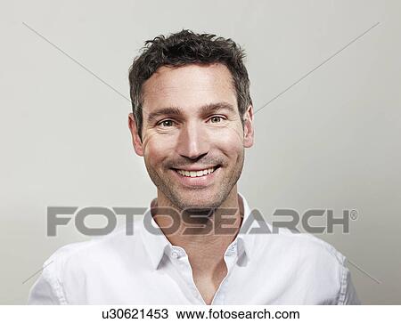 Stock Image - Portrait of smiling man. Fotosearch